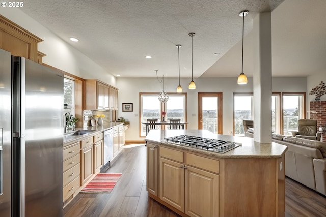 kitchen featuring a wealth of natural light, open floor plan, appliances with stainless steel finishes, and a sink