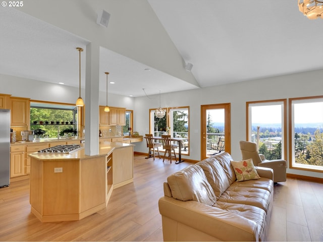 living area featuring recessed lighting, a wealth of natural light, and light wood-style floors