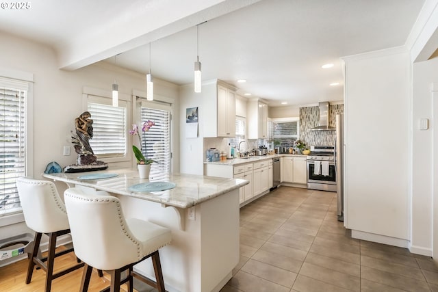5200 SW Scholls Ferry Rd, Portland, OR 97225 - kitchen with appliances with stainless steel finishes, a sink, a breakfast bar area, a peninsula, and decorative backsplash