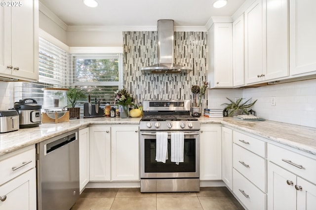 5200 SW Scholls Ferry Rd, Portland, OR 97225 - kitchen featuring wall chimney range hood, appliances with stainless steel finishes, light tile patterned floors, and tasteful backsplash