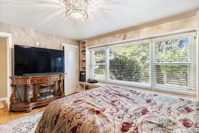 5200 SW Scholls Ferry Rd, Portland, OR 97225 - bedroom featuring a notable chandelier and wood finished floors