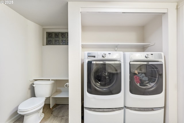 5200 SW Scholls Ferry Rd, Portland, OR 97225 - washroom featuring separate washer and dryer, laundry area, baseboards, and wood finished floors