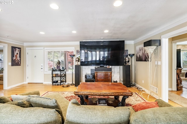 5200 SW Scholls Ferry Rd, Portland, OR 97225 - living room featuring crown molding, a wood stove, plenty of natural light, and wood finished floors