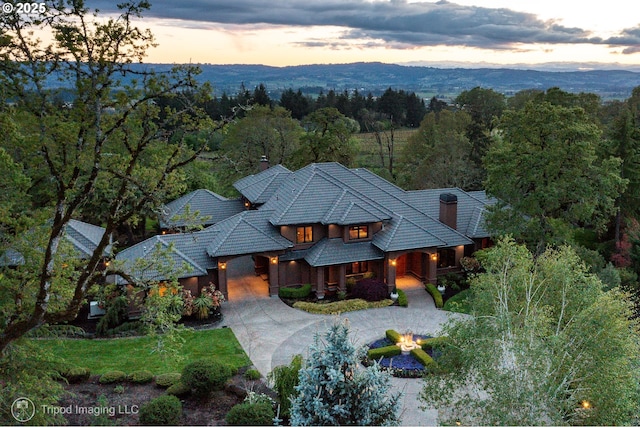 aerial view at dusk featuring a mountain view