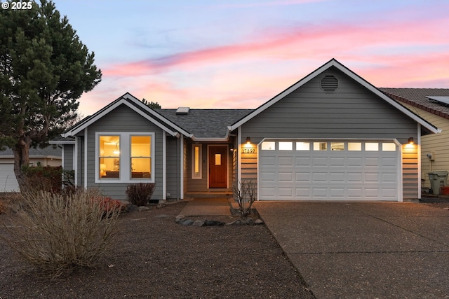 ranch-style home featuring concrete driveway and a garage