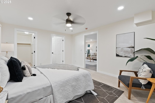 bedroom featuring recessed lighting, dark colored carpet, baseboards, ceiling fan, and a spacious closet