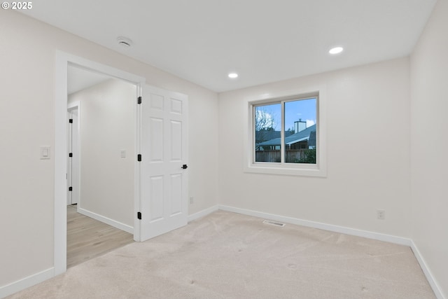 unfurnished room with recessed lighting, visible vents, baseboards, and light carpet