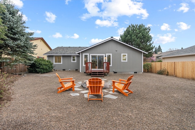 back of house with a patio, fence, roof with shingles, a fire pit, and crawl space