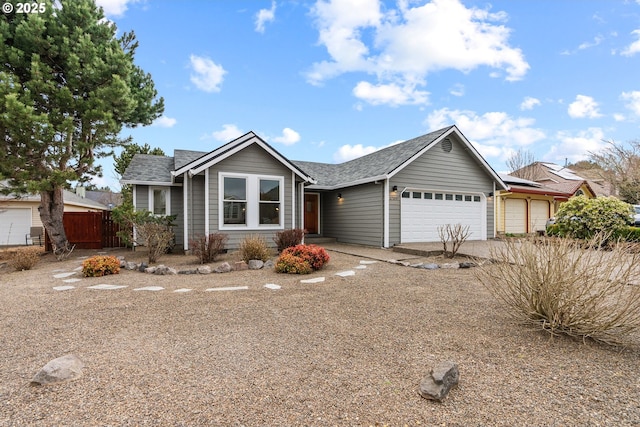 ranch-style house featuring driveway, roof with shingles, a garage, and fence