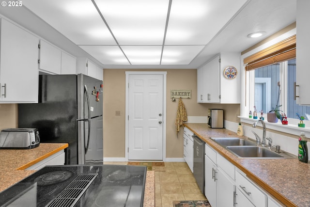 1588 20th St, Florence, OR 97439 - kitchen featuring appliances with stainless steel finishes, white cabinetry, and light tile patterned flooring