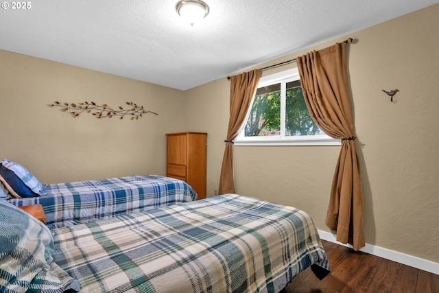 1588 20th St, Florence, OR 97439 - bedroom with wood finished floors and a textured ceiling