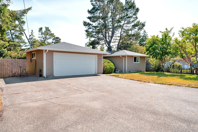 1588 20th St, Florence, OR 97439 - ranch-style house with a garage, concrete driveway, and an outbuilding