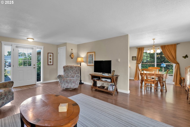 1588 20th St, Florence, OR 97439 - living area with a chandelier, a textured ceiling, and wood finished floors