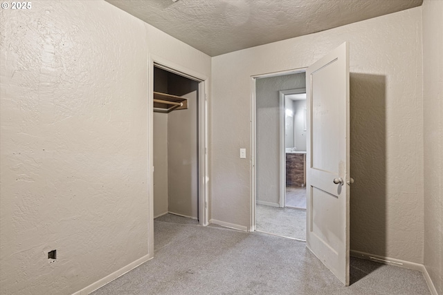 254 Humphrey Addition Rd, Glendale, OR 97442 - unfurnished bedroom featuring a textured wall, a textured ceiling, carpet floors, baseboards, and a closet