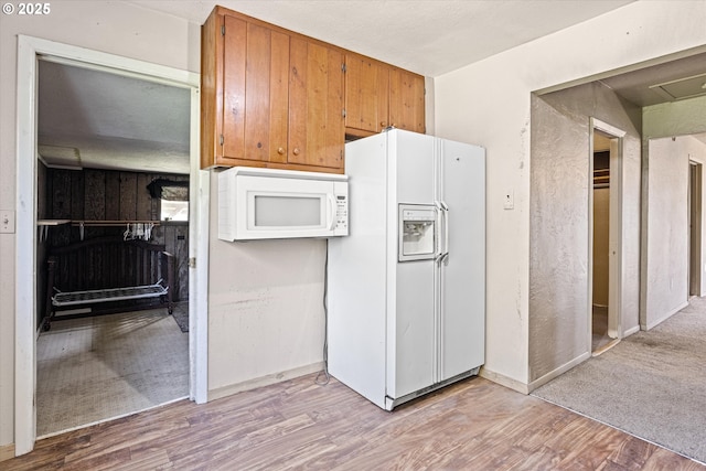 254 Humphrey Addition Rd, Glendale, OR 97442 - kitchen with white appliances, light wood-style flooring, brown cabinets, and baseboards