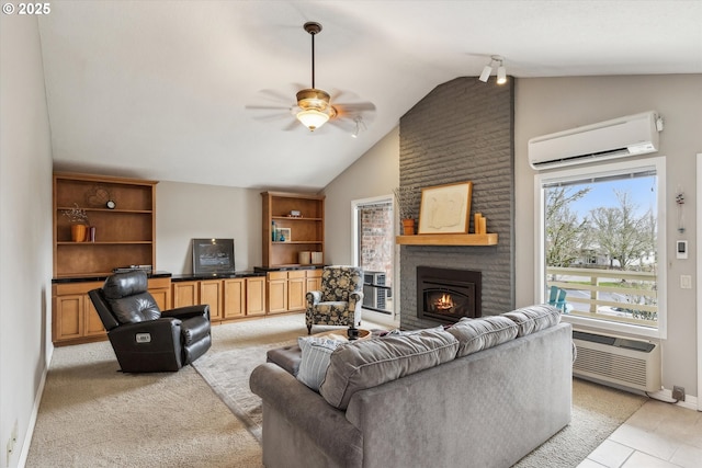 living room featuring baseboards, an AC wall unit, a wall unit AC, a fireplace, and a ceiling fan