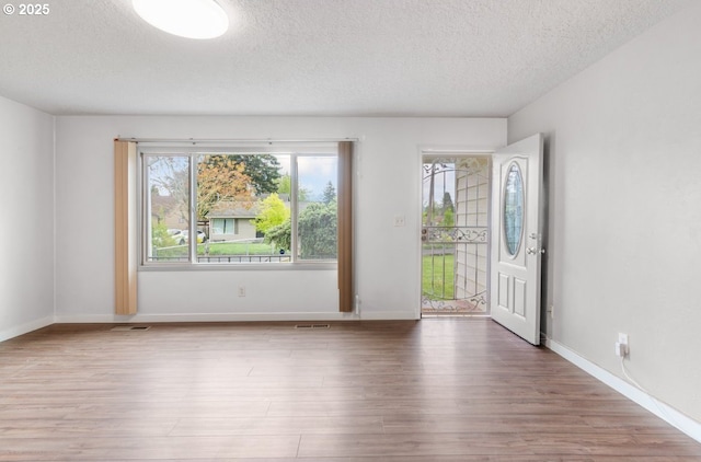 10525 SE Mitchell St, Portland, OR 97266 - unfurnished room with a textured ceiling, wood finished floors, and baseboards