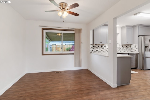 10525 SE Mitchell St, Portland, OR 97266 - unfurnished room featuring wood finished floors, a ceiling fan, and baseboards