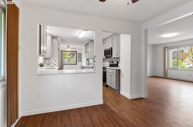 10525 SE Mitchell St, Portland, OR 97266 - kitchen with appliances with stainless steel finishes, ceiling fan, backsplash, and light countertops