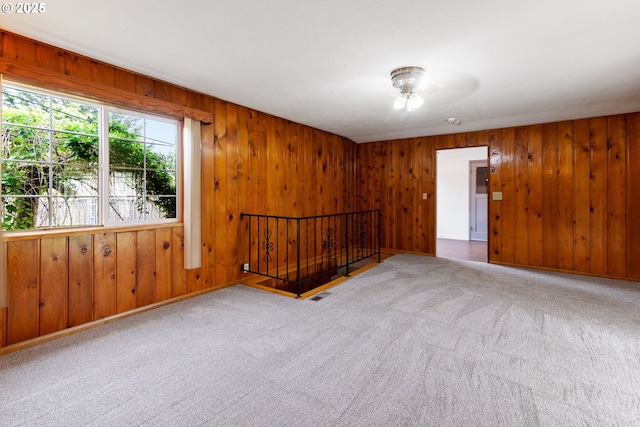 10525 SE Mitchell St, Portland, OR 97266 - carpeted spare room with wood walls and ceiling fan