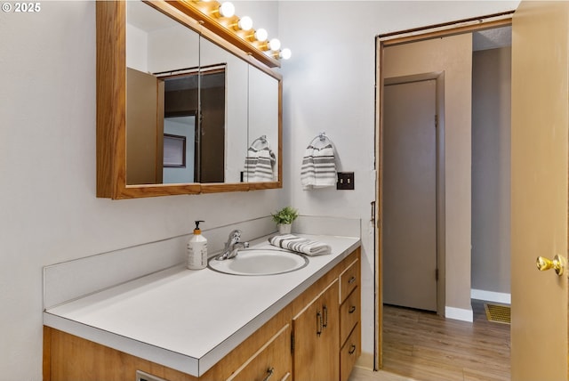 10525 SE Mitchell St, Portland, OR 97266 - bathroom featuring vanity, wood finished floors, and baseboards