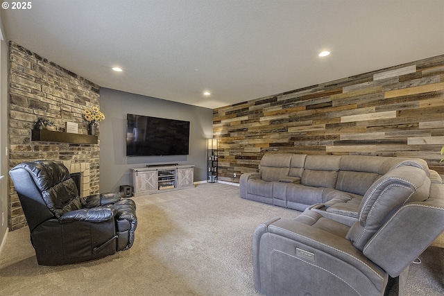 living area with recessed lighting, wooden walls, carpet flooring, and a textured ceiling