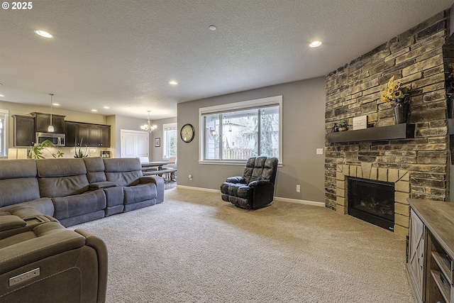 living room with a textured ceiling, a fireplace, baseboards, and light carpet