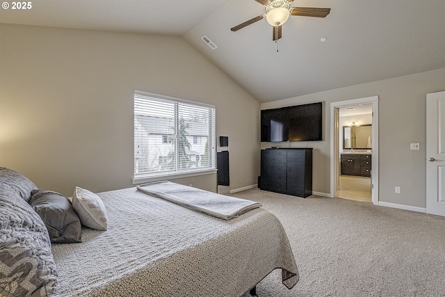 bedroom with visible vents, baseboards, vaulted ceiling, ensuite bathroom, and light colored carpet