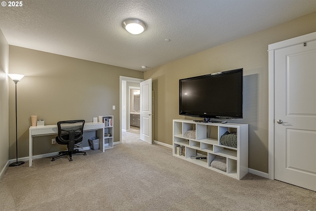 office with a textured ceiling, baseboards, and carpet floors