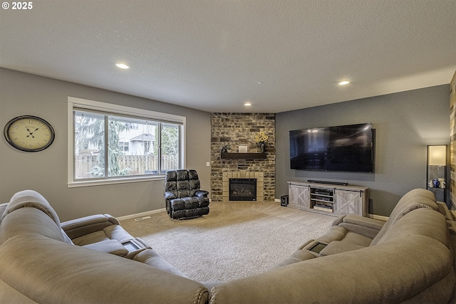 living room featuring carpet flooring, a fireplace, and a textured ceiling