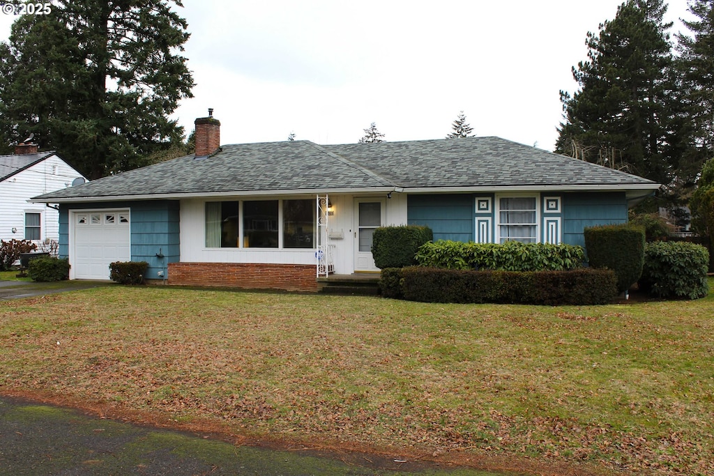 ranch-style house with a garage and a front yard