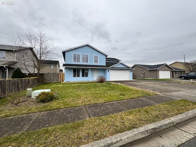 traditional home with a garage, fence, aphalt driveway, and a front yard