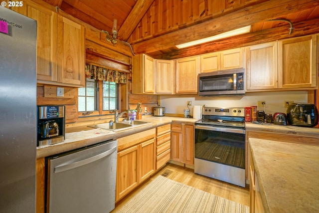 31975 Berlin Rd, Lebanon, OR 97355 - kitchen featuring light wood-type flooring, a sink, stainless steel appliances, wood ceiling, and vaulted ceiling with beams