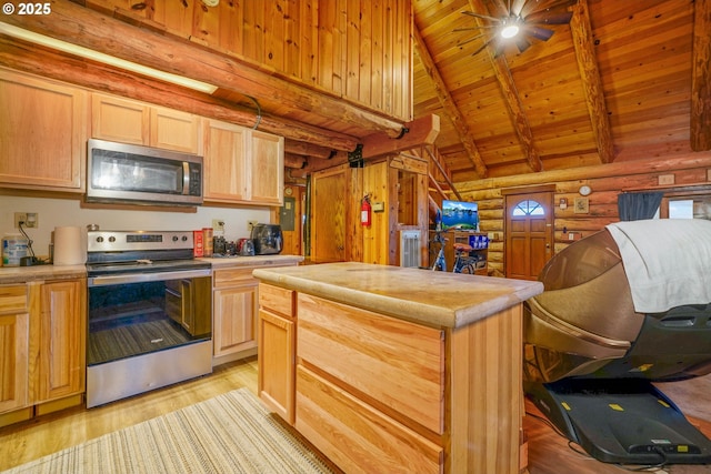 31975 Berlin Rd, Lebanon, OR 97355 - kitchen featuring light brown cabinetry, light wood-type flooring, light countertops, beam ceiling, and appliances with stainless steel finishes
