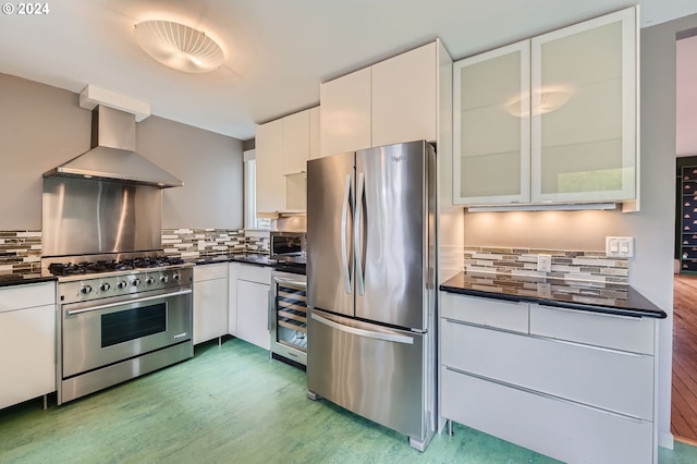 9116 N Willamette Blvd, Portland, OR 97203 - kitchen with appliances with stainless steel finishes, wall chimney range hood, dark countertops, wine cooler, and backsplash