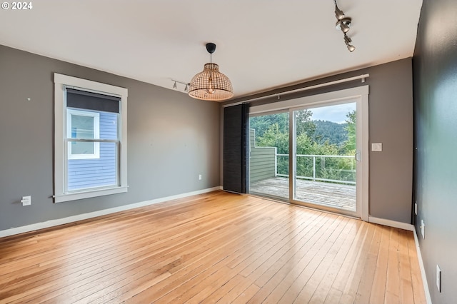 9116 N Willamette Blvd, Portland, OR 97203 - empty room with light wood-type flooring and rail lighting