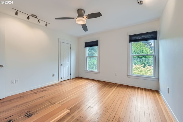 9116 N Willamette Blvd, Portland, OR 97203 - spare room with rail lighting, light wood-type flooring, and a ceiling fan
