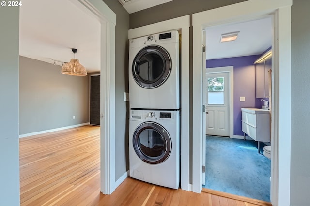 9116 N Willamette Blvd, Portland, OR 97203 - laundry room featuring stacked washer / drying machine and wood finished floors
