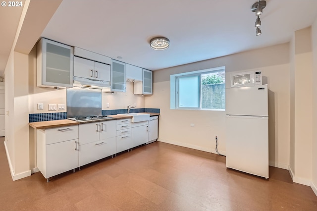 9116 N Willamette Blvd, Portland, OR 97203 - kitchen with white appliances, under cabinet range hood, glass insert cabinets, white cabinets, and light floors