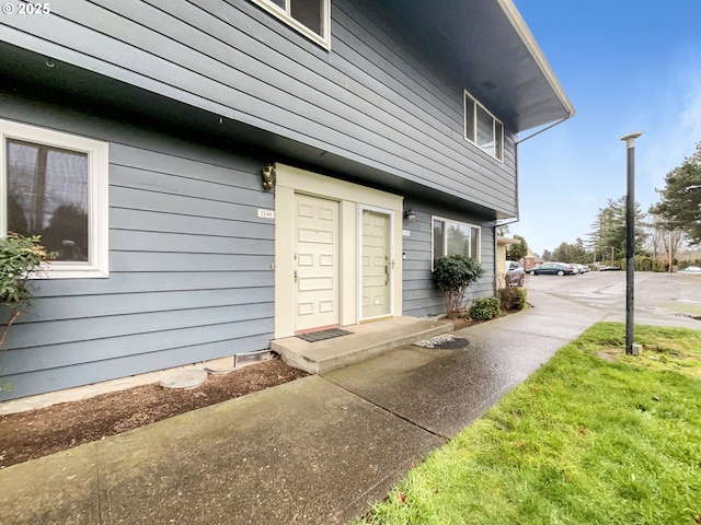 doorway to property with a yard