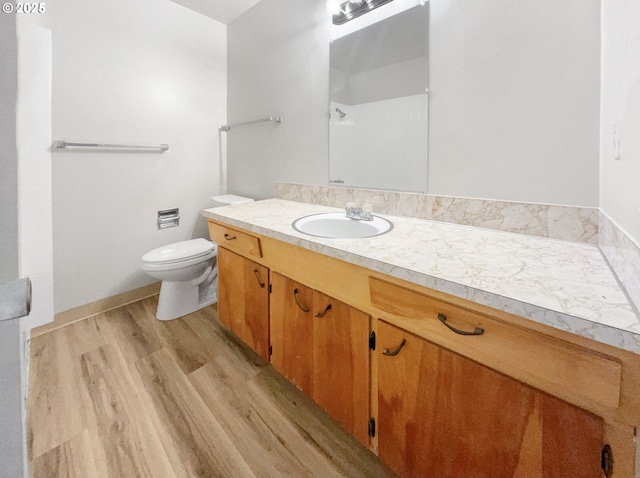 bathroom with vanity, hardwood / wood-style flooring, and toilet