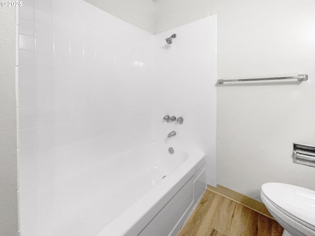 bathroom featuring hardwood / wood-style floors, toilet, and shower / bath combination