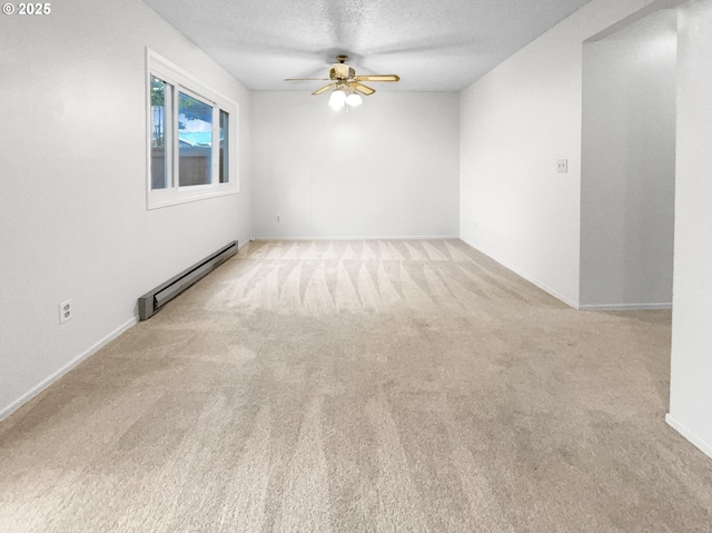 carpeted spare room featuring baseboard heating, ceiling fan, and a textured ceiling