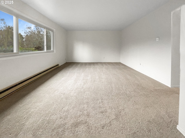 carpeted empty room with baseboard heating