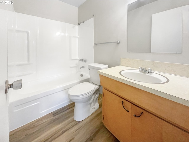 full bathroom featuring hardwood / wood-style flooring,  shower combination, toilet, and vanity