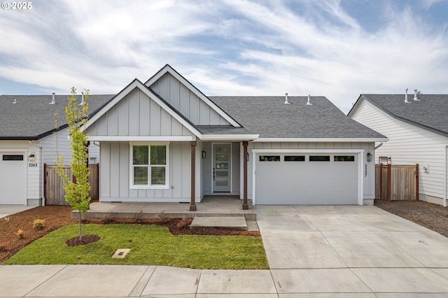 3237 Wildflower Dr, Springfield, OR 97478 - view of front of house featuring a shingled roof, board and batten siding, covered porch, driveway, and a garage