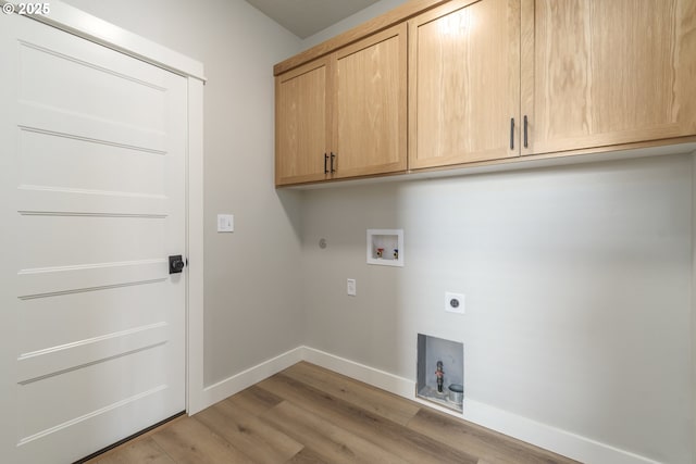 3237 Wildflower Dr, Springfield, OR 97478 - laundry area with cabinet space, hookup for an electric dryer, washer hookup, light wood finished floors, and hookup for a gas dryer