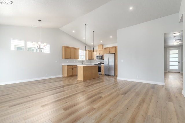 3237 Wildflower Dr, Springfield, OR 97478 - kitchen featuring stainless steel appliances, open floor plan, a center island, a chandelier, and high vaulted ceiling