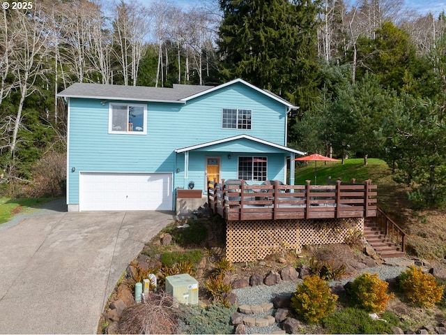 traditional-style home featuring stairs, a wooden deck, concrete driveway, and an attached garage