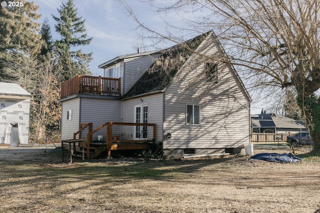 back of house featuring a wooden deck